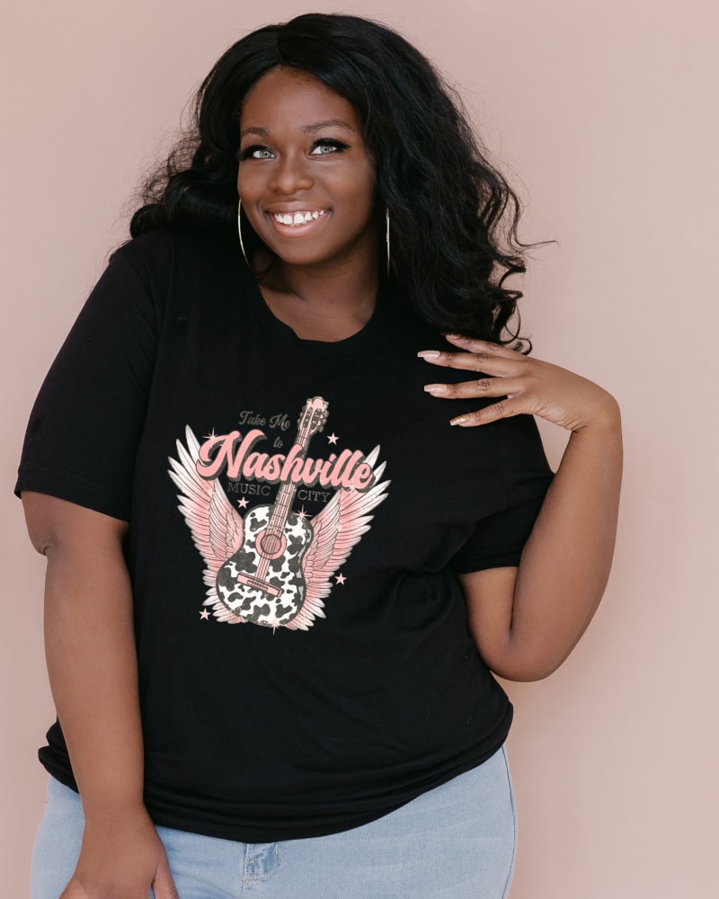 Front of a model wearing a size Large Take Me To Nashville Winged Guitar in Black by Simply Sage Market. | dia_product_style_image_id:281611